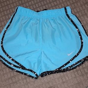 blue nike shorts with black and white detail